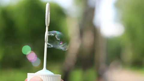 Unrecognizable man blowing soap bubbles. Soap bubbles close-up Stock Footage 318251985