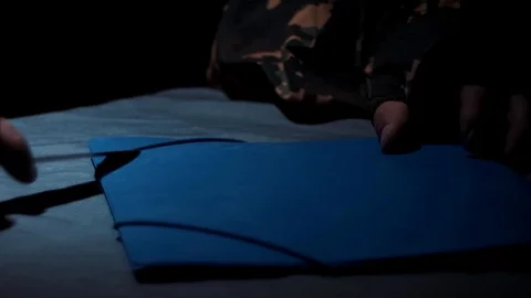 Unrecognizable man with blue folder and knife Video stock 90524888