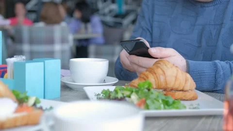 Unrecognizable man businessman sitting at table in cafe cafeteria restaurant Stock Footage 244051836