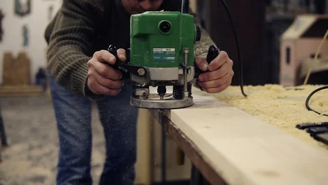 Unrecognizable man carpenter working with handle grinding machine, polishing the Stock Footage 121451520