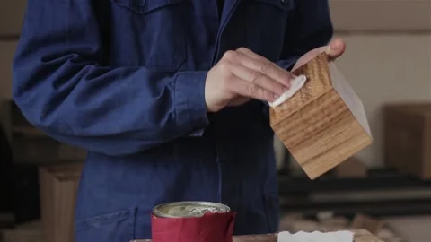 Unrecognizable man carpenter in workshop oiling polishing wood planking box item 스톡 동영상 88446411