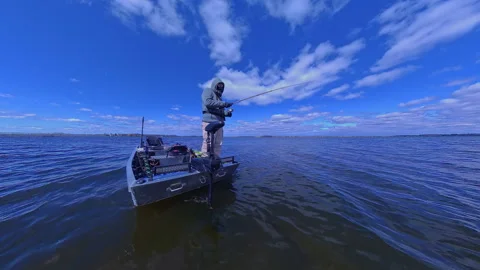 Unrecognizable man casting rod and spinning fishing reel on small fishing b.. Stock Footage 346309870