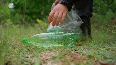 Unrecognizable man cleans up garbage in forest closeup Stock Footage 158122161