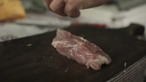 Unrecognizable man cuts meat used knife, act inside the house on countryside Stock Footage 99486559