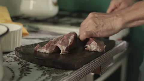 Unrecognizable man cuts meat used knife, act inside the house on countryside Stock Footage 99487463
