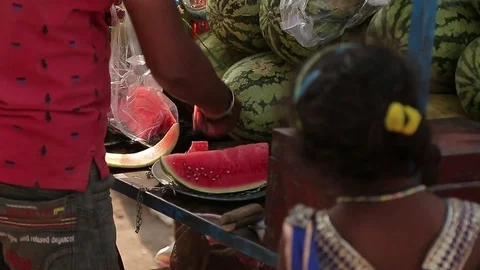Unrecognizable man cuts watermelon with knife. Pitchman. Many watermelons. Stock Footage 80923768