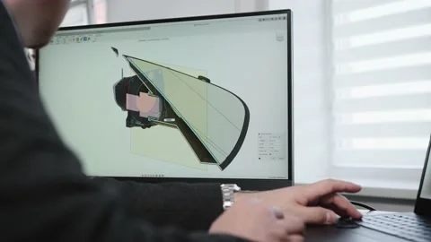 An unrecognizable man develops the design of a part. An engineer works with a 3D 動画素材 202829189