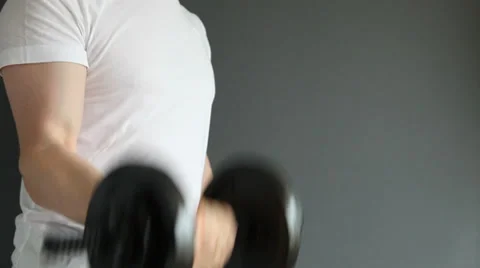 Unrecognizable man doing exercises with dumbbells Stock Footage 30371143