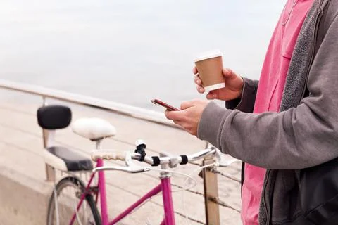 Unrecognizable man with a drink using mobile phone Stock Photos