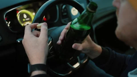 Unrecognizable man driver sitting in car with beer Stock Footage 261506860