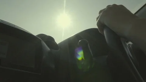 Unrecognizable man driving car. Hands on steering wheel. Sunny day. Slow motion 스톡 동영상 84886823
