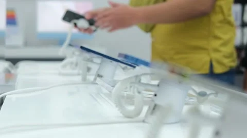An unrecognizable man in an electronics store chooses a new smartphone for Stock Footage 197903849