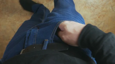 Unrecognizable man gets out of the pocket of jeans bag with medical marijuana. Stock Footage 128288771