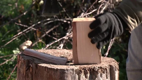 An unrecognizable man in gloves cuts a deck of wood. Chop wood for home heating Stock Footage 221619725