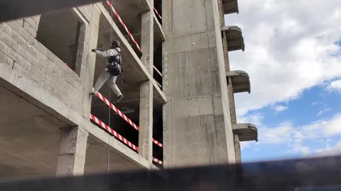 Unrecognizable man in gray overall and black helmet, industrial climber, ditches Video stock 228754764