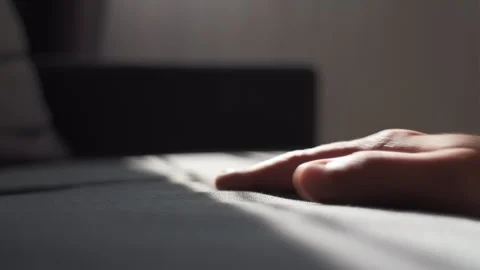 Unrecognizable man hand pressing light sofa for comfortable sitting at home Stock Footage 248764316