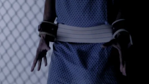 UNRECOGNIZABLE MAN IN HAND RESTRAINTS.  4K, 10 BIT, 4:2:2. Stock Footage 123495536