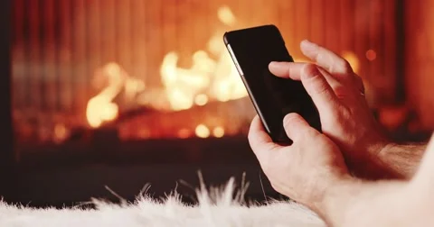 Unrecognizable Man Hands Using SmartPhone Fireplace. 4K SLOW MOTION 120FPS. 스톡 동영상 69261063