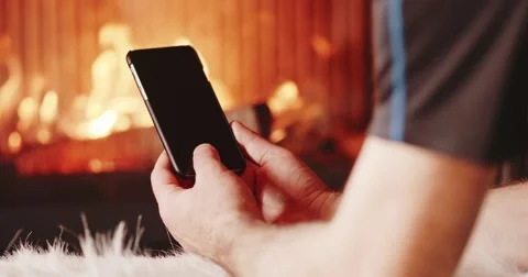 Unrecognizable Man Hands Using SmartPhone Fireplace. 4K SLOW MOTION 120FPS. 스톡 동영상 69261944
