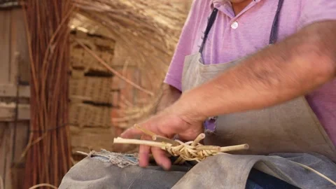 Unrecognizable man hands weaving fast a wicker basket. Small business in La.. Stock Footage 285425328