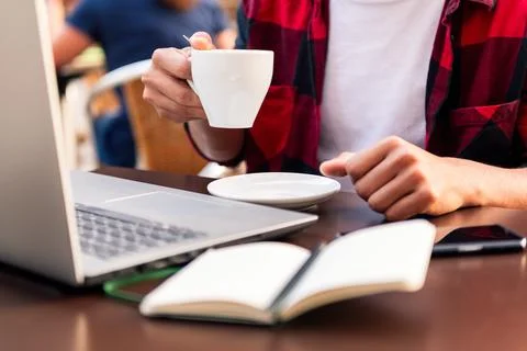 Unrecognizable man holding a coffee while working Stock Photos