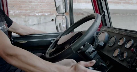 Unrecognizable man holding his hands on steering wheel and driving Truck View Stock Footage 134577271