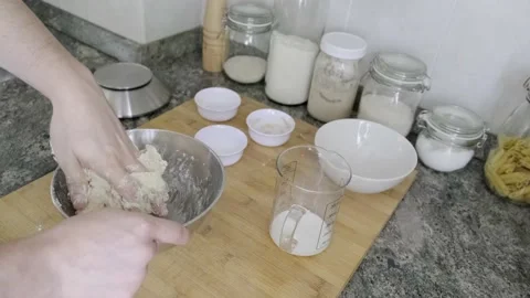 Unrecognizable man kneading bread dough and adding salt 스톡 동영상 131418886