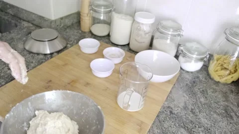 Unrecognizable man kneading bread dough on a wood board Stock Footage 131418959