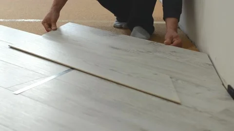 Unrecognizable man laying laminate flooring Stock Footage 169531097