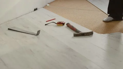 Unrecognizable man laying laminate flooring Stock Footage 195953981
