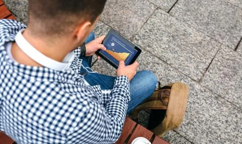 Unrecognizable man looking cryptocurrencies in tablet Stock Photos