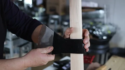 Unrecognizable man making a handmade ax with wooden stick, in his workshop. Stock Footage 203085492