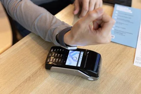 Unrecognizable man making wireless or contactless payment using smartwatch ov Stock Photos