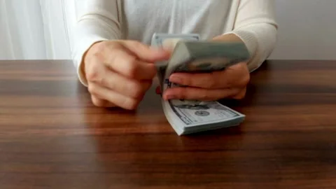 Unrecognizable man managing and calculating his dollar money salary at desk. Stock Footage 266475803
