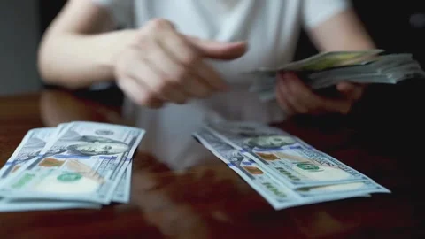 Unrecognizable man managing and calculating his dollar money salary at desk. Stock-Footage 336264243