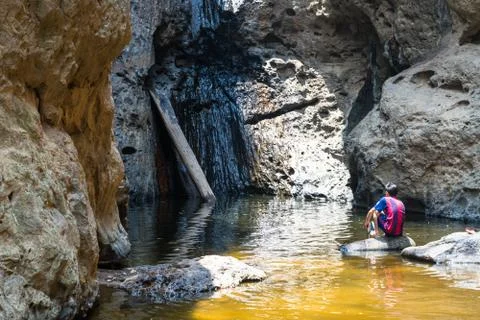 Unrecognizable man at the Mo Paeng waterfall in Pai district, north of Thailand. Stock Photos