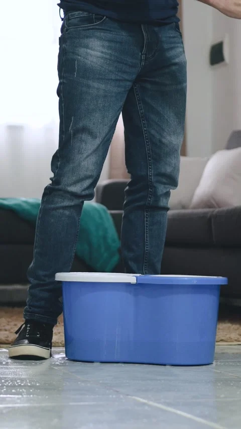 Unrecognizable man mopping floor at home interior Stock Footage 284257319