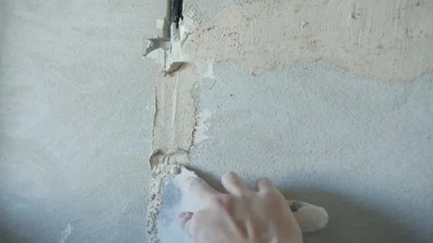 Unrecognizable man plastering concrete wall with wire Stock Footage 154530609