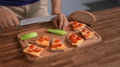 Unrecognizable man preparing a tasty snack. Bruschetta with cheese and Stock Footage 316286847