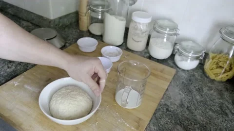 Unrecognizable man putting bread dough in a bowl to let it rise 스톡 동영상 131419017