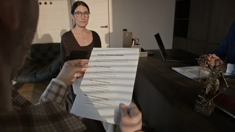 Unrecognizable Man Reading Divorce Process Overview in Office of Lawyer Stock Footage 334735497