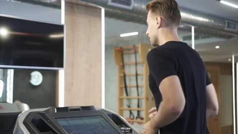 Unrecognizable man running on treadmill machine in gym Stock Footage 120405697