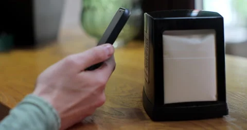 Unrecognizable man scanning QR code on table in restaurant or cafe. Online menu Stock Footage 197613062