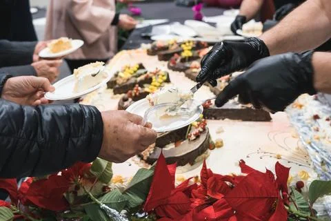 Unrecognizable man serving big cake to guests celebrating Stock Photos