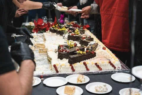 Unrecognizable man serving big cake to guests celebrating Stock Photos