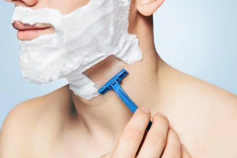 Unrecognizable man is shaving with razor Stock Photos