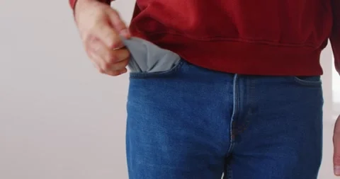 Unrecognizable man showing empty pockets of jeans, demonstrating bankruptcy and Stock Footage 304870670