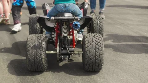 Unrecognizable man sitting on ATV, close-up rear view Stock Footage 130375238