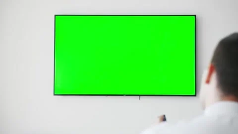 Unrecognizable man sitting on couch at home, watching tv shows with chroma-key Stock Footage 138903468