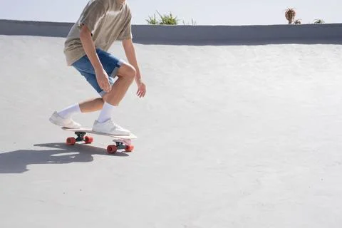 Unrecognizable Man Skating Down Cement Ramp with blank space Foto stock